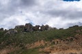 Green hills under blue sky and white clouds