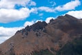 Green hills under blue sky and white clouds