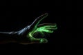 Green hologram of hand on black background. Generate ai