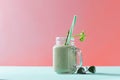 Green homemade smoothie from organic vegetables with asparagus and celery in a mason jar on duotone background in color Royalty Free Stock Photo