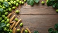 Green hops and wheat ears border rustic wood table. Fresh ingredients for brewing beer or making bread. Natural plant elements Royalty Free Stock Photo