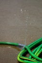 Green Hose Leaking Spraying Water Royalty Free Stock Photo