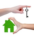 Green house with key in hands Royalty Free Stock Photo