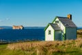 Green house & Rocher Perce rock in Gaspe Peninsula, Quebec, Gaspesie Royalty Free Stock Photo