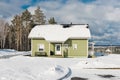 Green houses in snow forest.