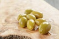 Green huge olives on wood table