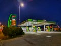 Green Hungarian empty petrol station during the night