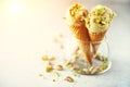 Green ice cream in waffle cone with chocolate and pistachio nuts on grey stone background. Summer food concept, copy Royalty Free Stock Photo