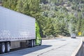 Green industrial carrier big rig semi truck tractor with extended cab for truck driver rest transporting cargo in reefer semi Royalty Free Stock Photo