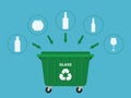 Green industrial garbage container and glass waste suitable for recycling. Bottles, glasses etc. Blue background. Royalty Free Stock Photo