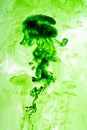 Green ink dispersing in water Royalty Free Stock Photo