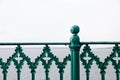 Green Iron fence details with the sea in the background Royalty Free Stock Photo