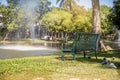 Green iron Stylish bench in summer park Royalty Free Stock Photo