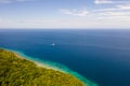 Green island with coral reef. Coast of Camiguin Island, Philippines, view from above