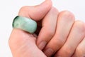 Green jade ring on thumb finger Royalty Free Stock Photo