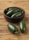 Green jalapeno peppers on a bowl over wooden table Royalty Free Stock Photo