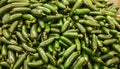 Green Jalapeno peppers piled up on a market stand. Royalty Free Stock Photo