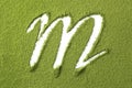 Green Japanese Matcha tea powder full frame and the letter M Royalty Free Stock Photo