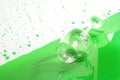 Green juice and glass splashing on background