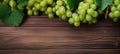 Green juicy grapes on wooden background