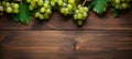 Green juicy grapes on wooden background