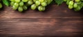 Green juicy grapes on wooden background