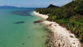 Green jungle and stony beach near sea. Tropical rainforest and rocks near calm blue sea on white sandy shore of Koh Samui paradise Royalty Free Stock Photo