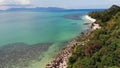 Green jungle and stony beach near sea. Tropical rainforest and rocks near calm blue sea on white sandy shore of Koh Samui paradise Royalty Free Stock Photo