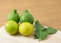 Green Kaffir Lime with Lemon Lime on Cutting Board Royalty Free Stock Photo