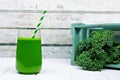 Green kale smoothie in a glass with crate of kale Royalty Free Stock Photo