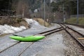 Green kayak with an oar on the railway rails in Safien, Switzerland.