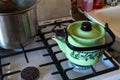 Green kettle boil on a gas stove