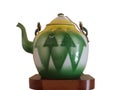 Green kettle with a yellow lid.