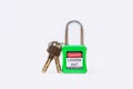 Green key lock and tag for process cut off electrical,the toggle tags number for electrical log out tag out on white background Royalty Free Stock Photo