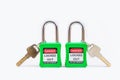 Green key lock and tag for process cut off electrical,the toggle tags number for electrical log out tag out on white background Royalty Free Stock Photo