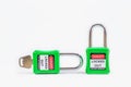 Green key lock and tag for process cut off electrical,the toggle tags number for electrical log out tag out on white background Royalty Free Stock Photo