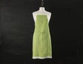 Green Kitchen Apron On Mannequin Over Black Background Royalty Free Stock Photo