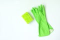 Green kitchen cleaning sponge and gloves on white background. Top view Royalty Free Stock Photo