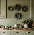 Green Kitchen With Wreaths on Wall