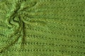 Green knit background with twisted folds