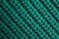 Green knitted sweater as background, closeup