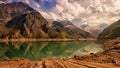 Green lake surrounded by several mountains around IT Royalty Free Stock Photo