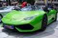 Green Lamboghini and Mercedes SLR parked on the pavement near each other in the street Royalty Free Stock Photo