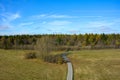 Green landscape from above, a path in the middle, with big meadow, trees and blue sky Royalty Free Stock Photo