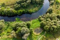 Green landscape with a bend in the river and a small pond