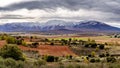 Green landscape with snowy mountains and dramatic sky in Somosierra Madrid Royalty Free Stock Photo