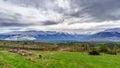 Green landscape with snowy mountains and dramatic sky in Somosierra Madrid Royalty Free Stock Photo