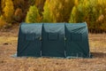 Green large basecamp tent on colorful mountains background