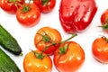 Green large cucumbers, one red bell pepper, red tomatoes on a green branch close-up Royalty Free Stock Photo