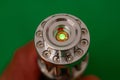 green laser light chrome metal flashlight front Royalty Free Stock Photo